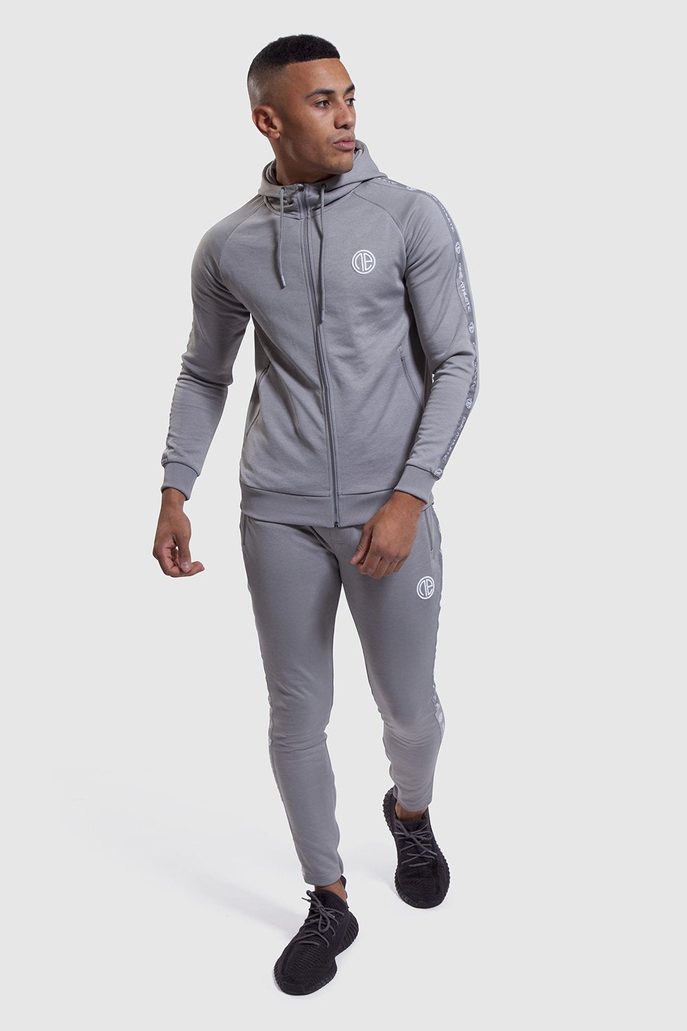 zipped up track top and gym joggers