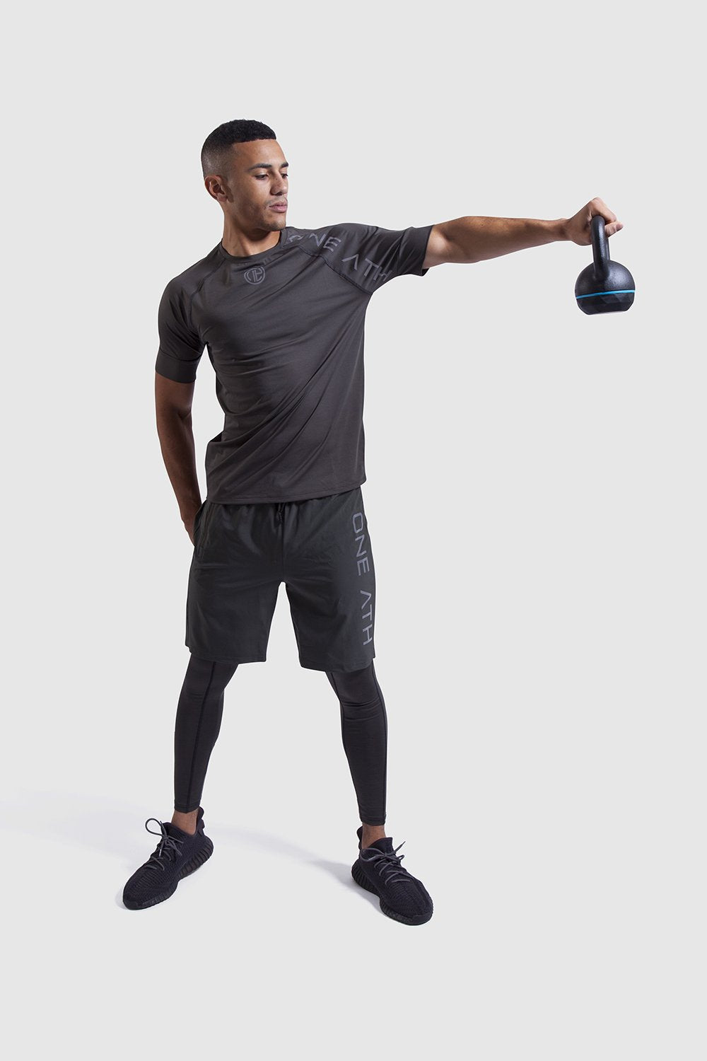 Man lifting weights in One Athletic Gymwear