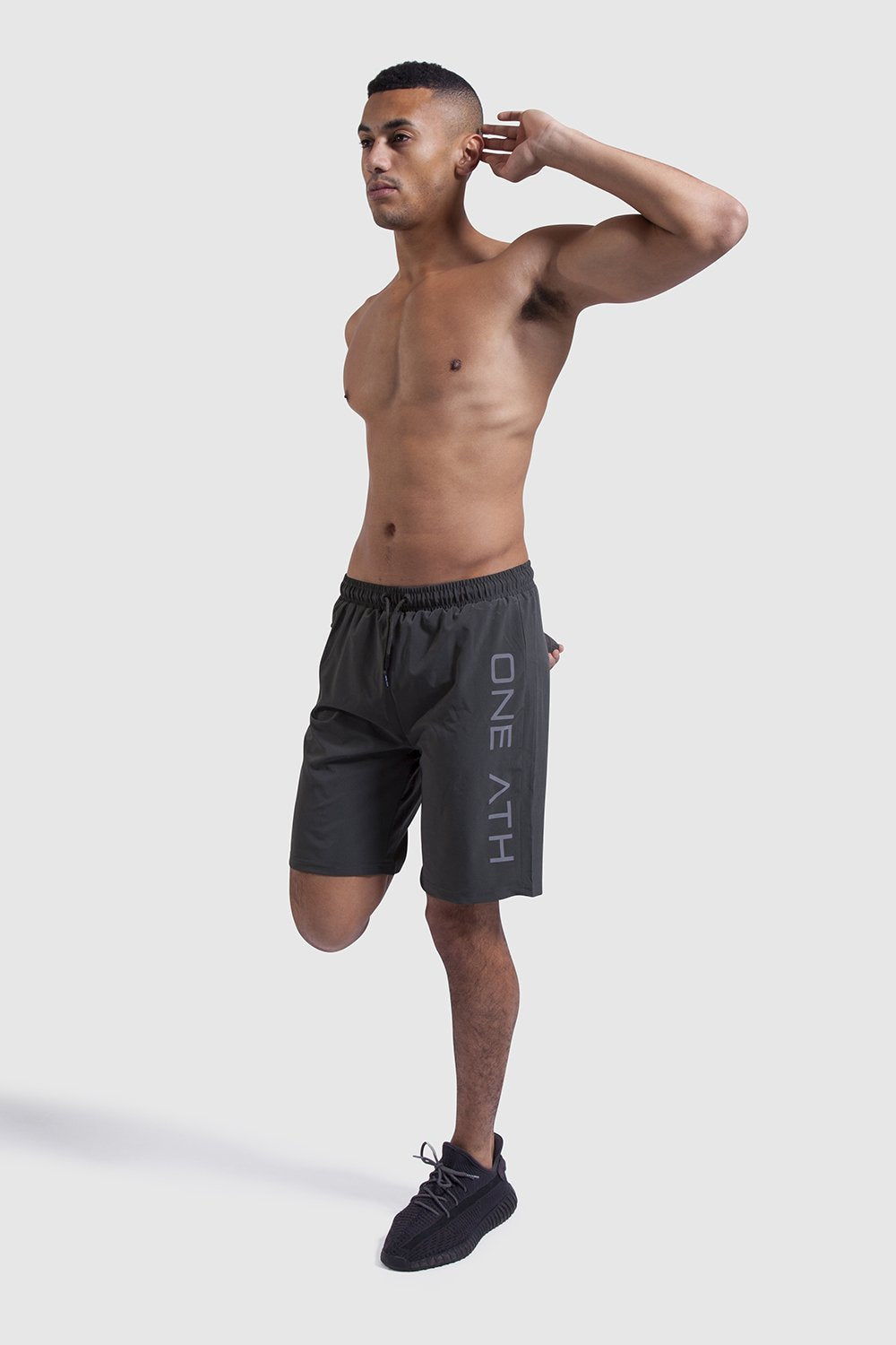 athlete stretching in mens training shorts